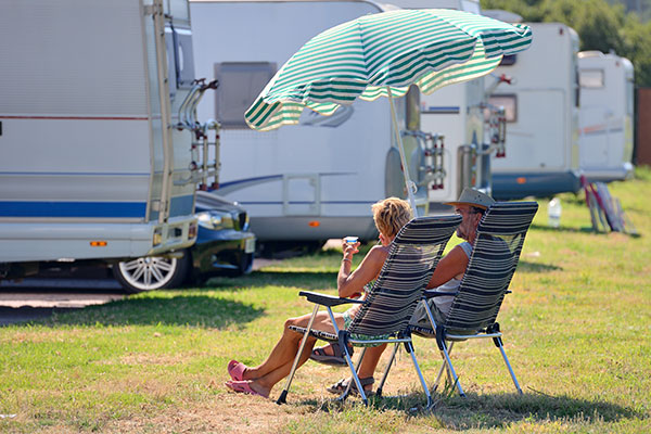 couple sitting on chairs at a campsite